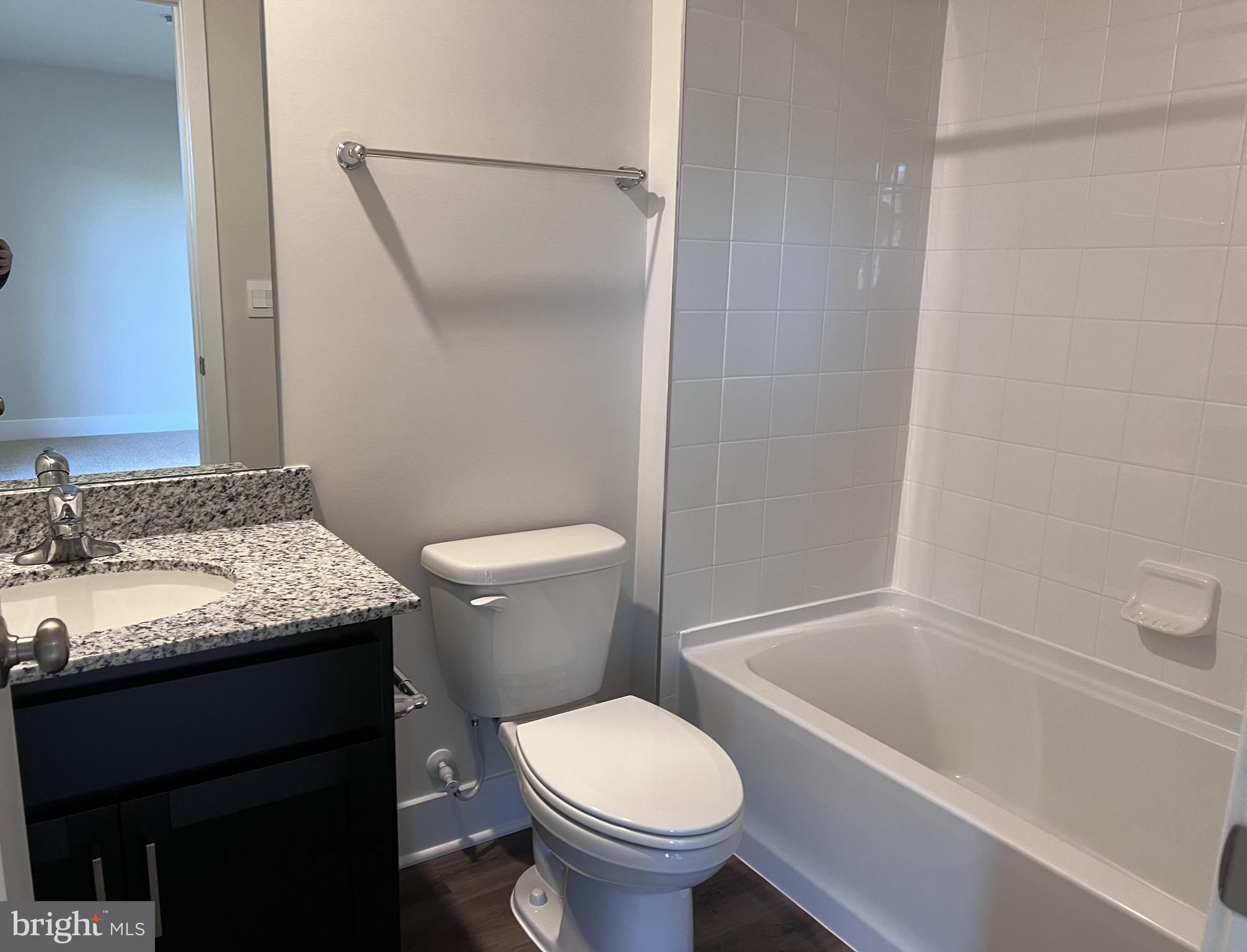 152 Munsee Circle Winchester, VA 22602 - Photo 4 of 19 a bathroom with a granite countertop toilet sink and mirror