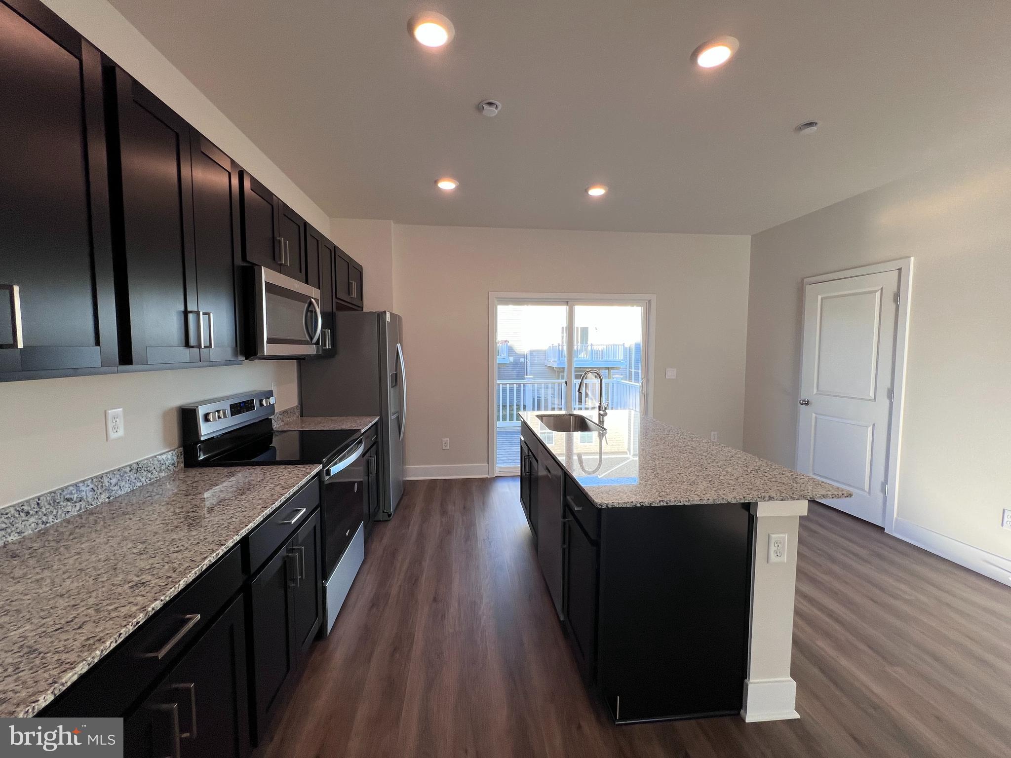 152 Munsee Circle Winchester, VA 22602 - Photo 6 of 19 a kitchen with stainless steel appliances granite countertop a stove a sink and a refrigerator