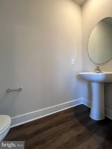a view of a room with wooden floor and glass door