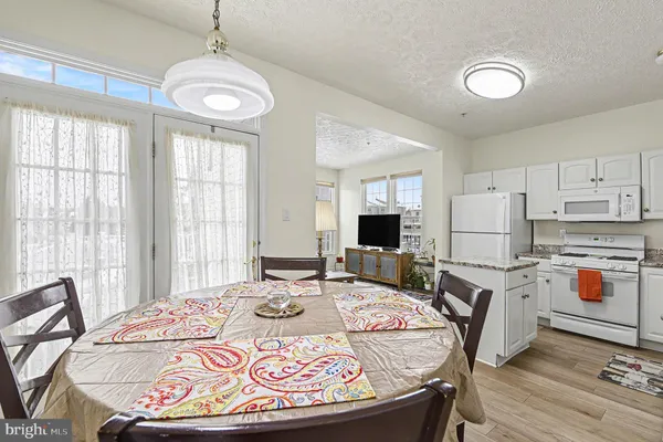 a very nice looking kitchen with granite countertop a stove two sinks and a refrigerator
