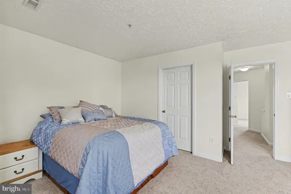 a bedroom with a bed and a view of bedroom