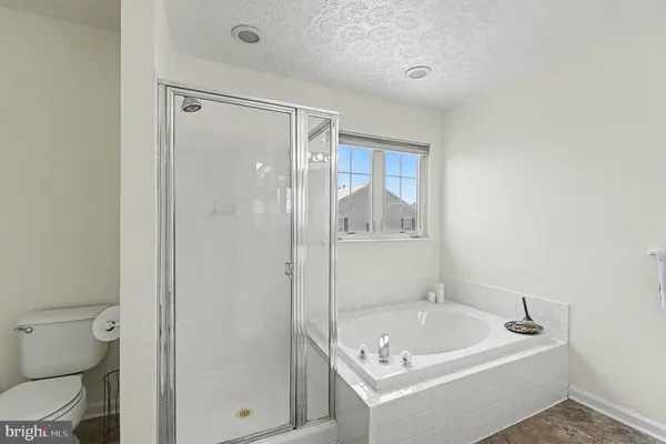 a bathroom with a tub a toilet and a sink