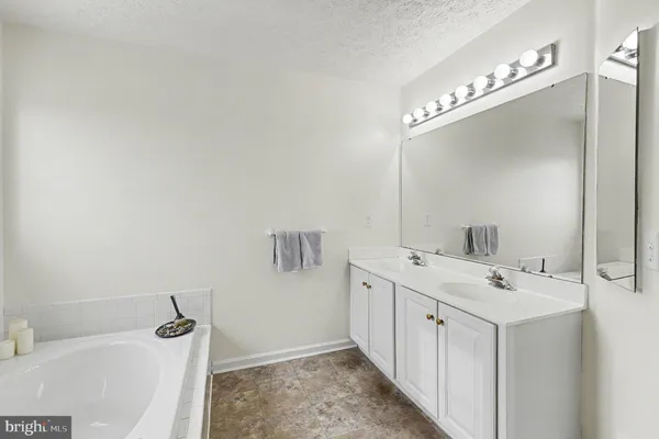 a bathroom with a double vanity sink a mirror and shower