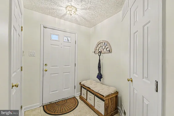 a room with a table chairs and a chandelier