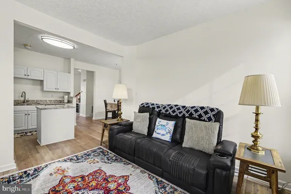 a living room with furniture and a lamp