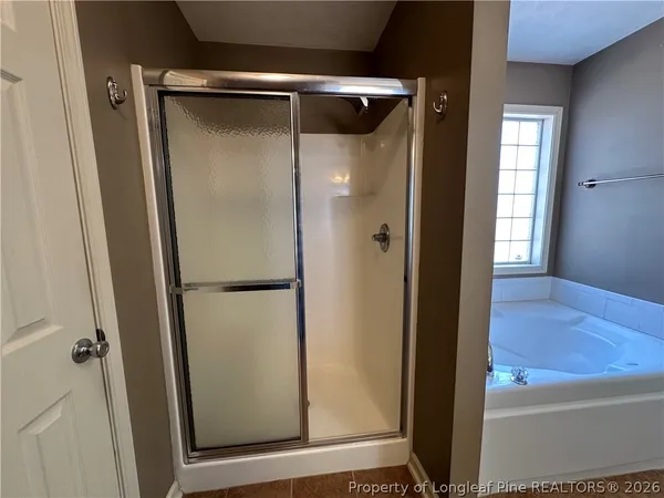 a bathroom with a glass shower door