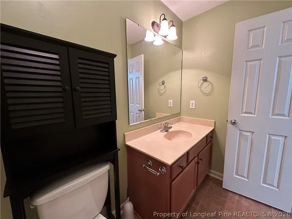 a bathroom with a sink vanity and a mirror