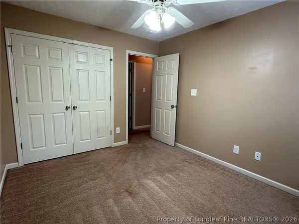 an empty room with closet area