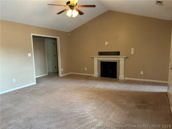a view of empty room with a fireplace