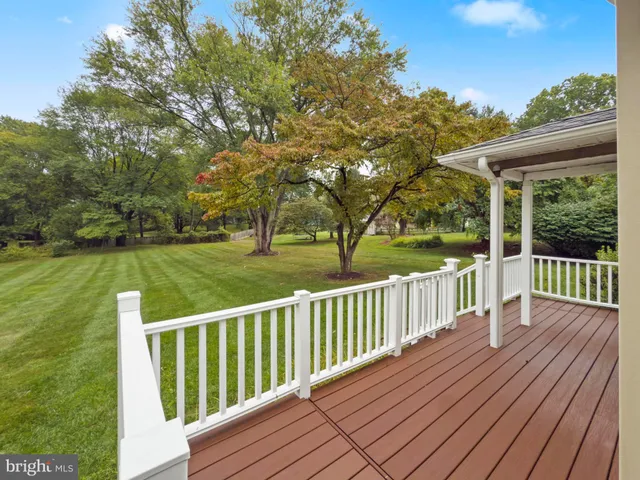 a view of a wooden deck with a yard