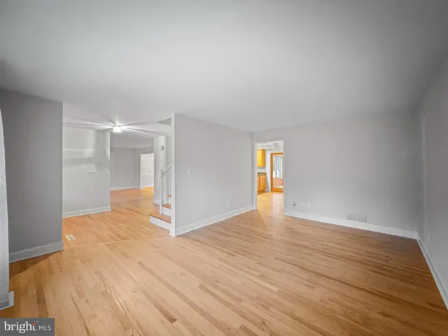 a view of an empty room and wooden floor