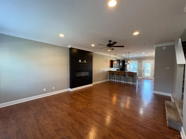 a view of kitchen with refrigerator and wooden floor