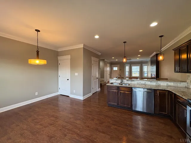 a large kitchen with granite countertop a stove and a sink