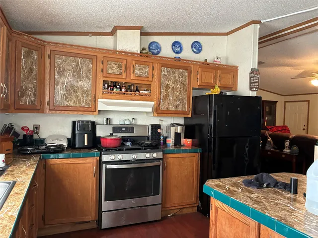 a kitchen with stainless steel appliances granite countertop a stove and a refrigerator