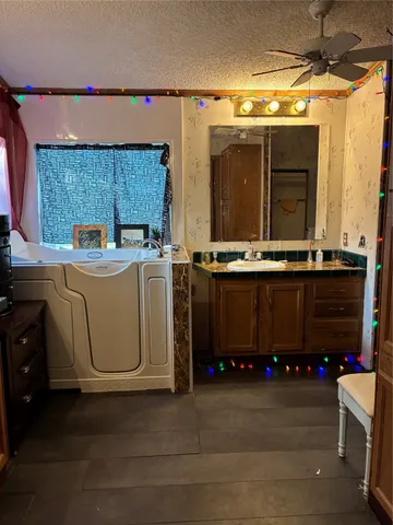 a utility room with stainless steel appliances a stove a sink dishwasher and a refrigerator