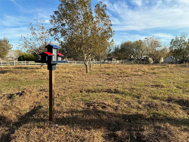 a street sign on a sidewalk next to a road