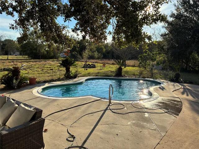 a view of a swimming pool with a patio