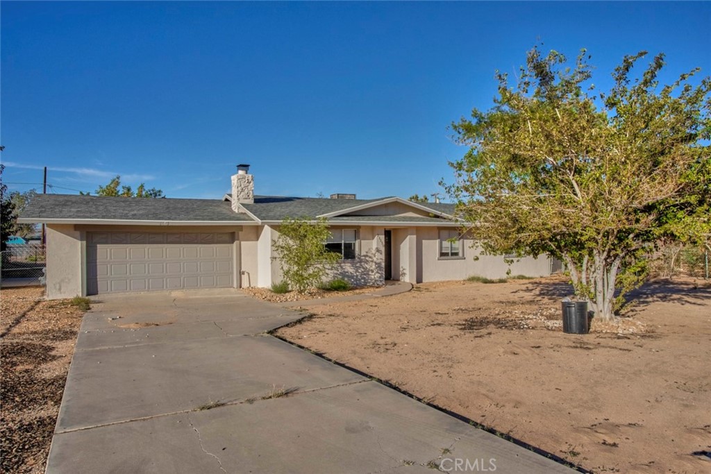 21150 Matawan Road Apple Valley, CA 92308 - Photo 1 of 1 a front view of a house with a yard and garage