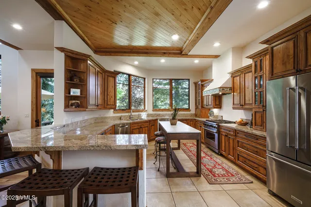 a bathroom with a granite countertop sink toilet a mirror and shower