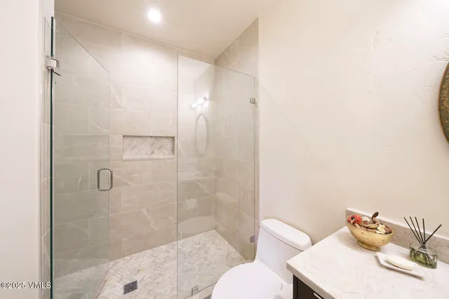 a view of a park with large trees and a barn in it