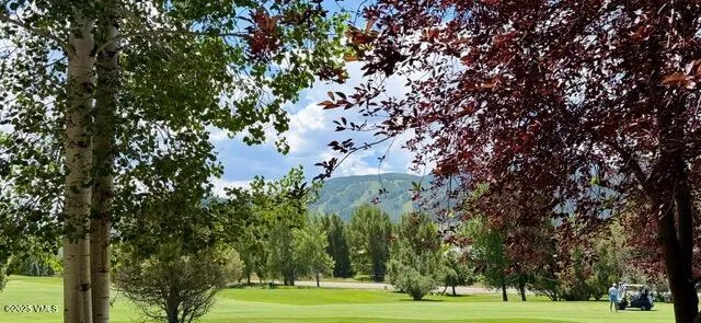a living room with furniture large window and a fireplace