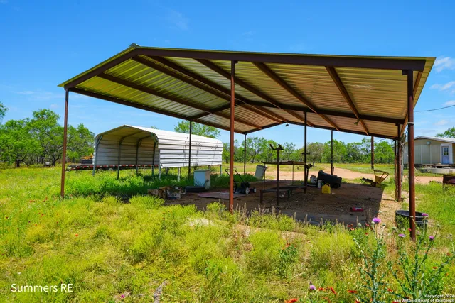 a view of a backyard with plants and a lake view