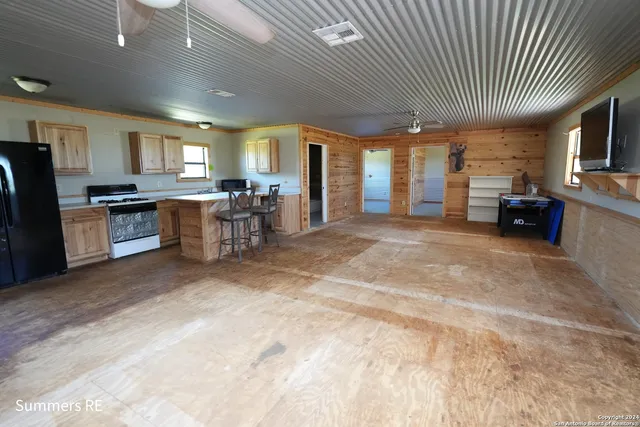 a large hall with stainless steel appliances granite countertop lots of counter top space