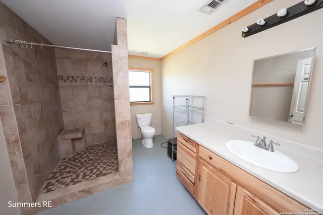 a spacious bathroom with a sink toilet and shower