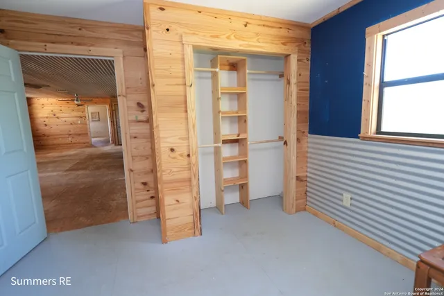a view of a room with wooden floor and windows
