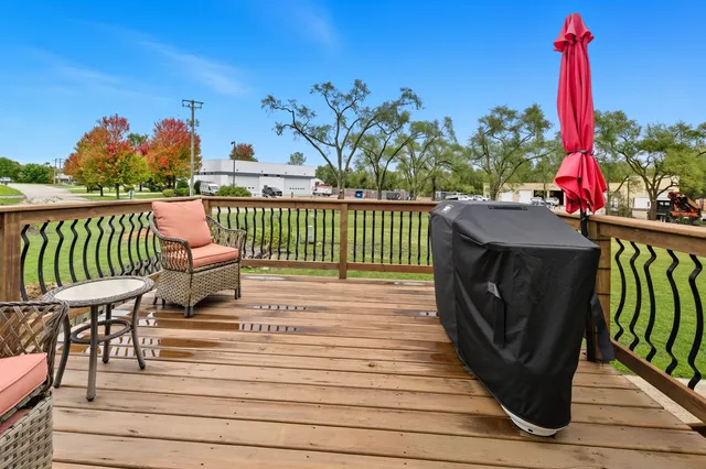 a view of a deck with wooden floor and outdoor seating