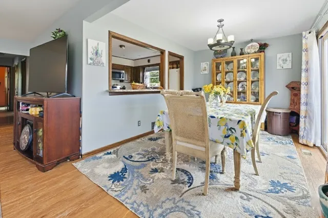 a living room with furniture a dining table and a chandelier