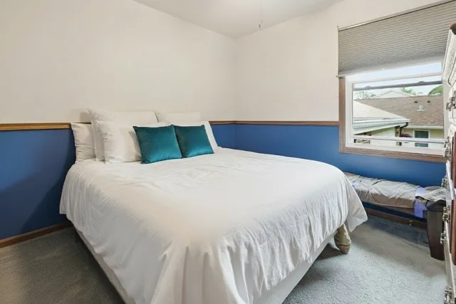 a bedroom with a bed and window