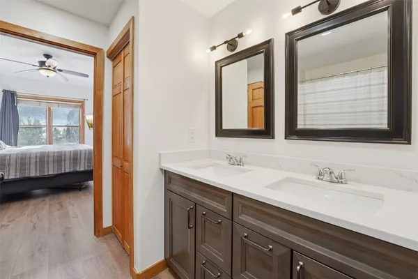 a en suite bathroom with a double vanity sink a mirror and a shower