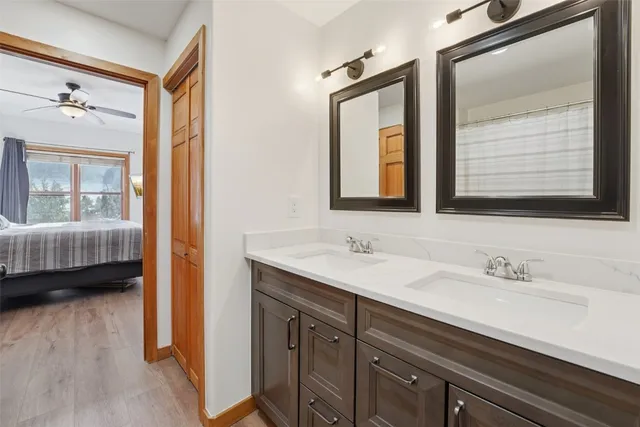 a en suite bathroom with a double vanity sink a mirror and a shower