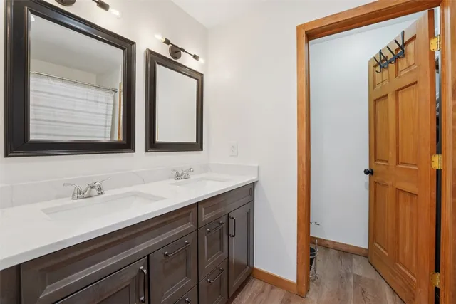 a bathroom with a double vanity sink and a mirror