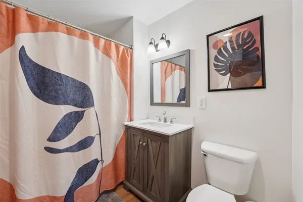 a bathroom with a toilet sink and mirror