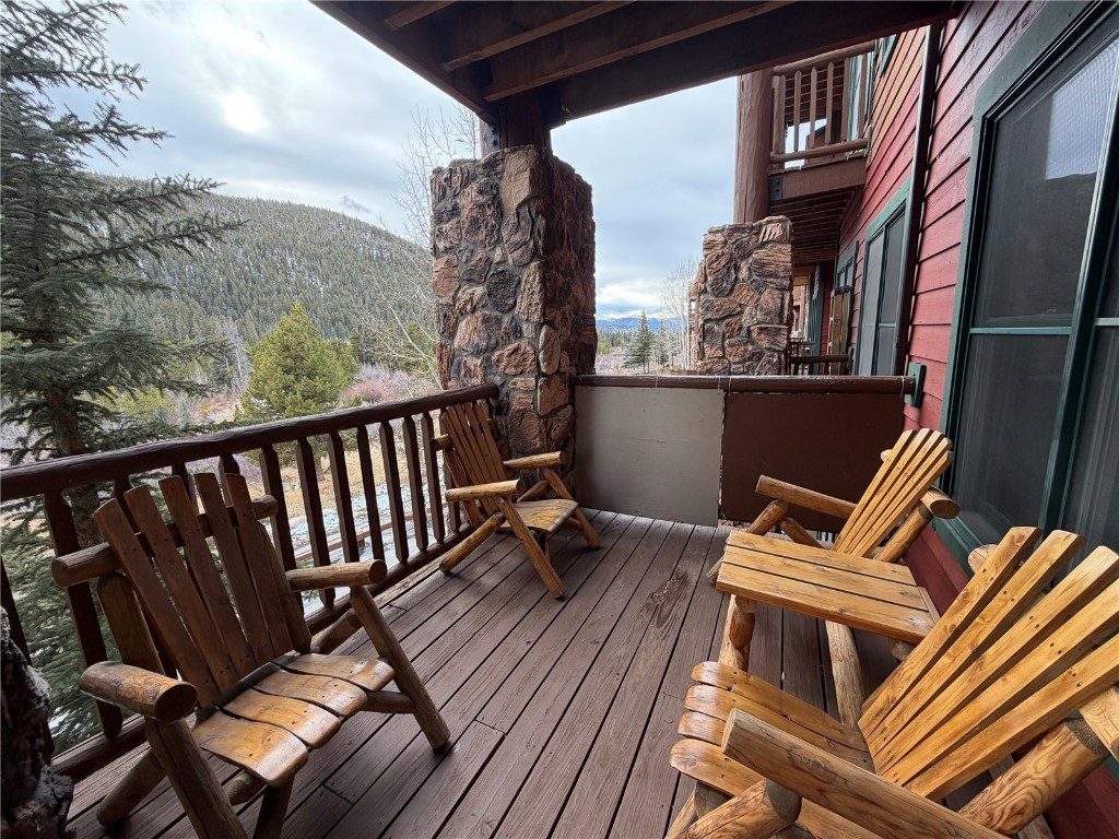 22714 Highway 6, Unit 5971 Keystone, CO 80435 - Photo 15 of 21 a balcony with wooden floor and outdoor seating