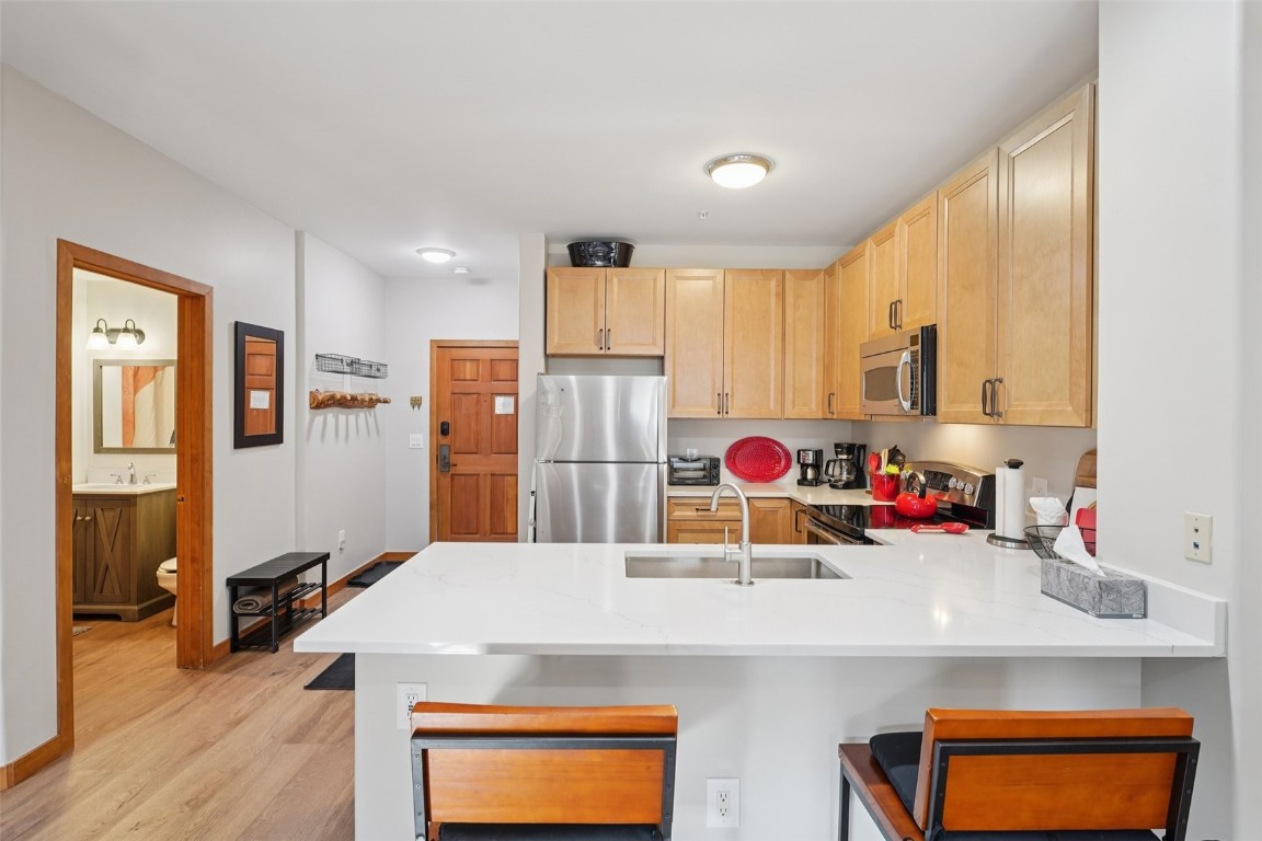22714 Highway 6, Unit 5971 Keystone, CO 80435 - Photo 5 of 21 a kitchen with stainless steel appliances a sink stove and refrigerator