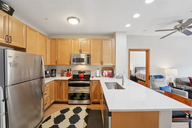 a kitchen with stainless steel appliances a stove a refrigerator sink and cabinets