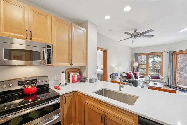 a kitchen with a stove a sink and a microwave