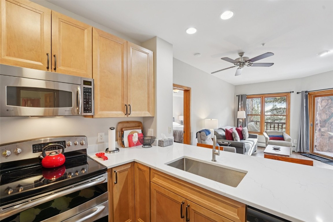 22714 Highway 6, Unit 5971 Keystone, CO 80435 - Photo 9 of 21 a kitchen with a stove a sink and a microwave