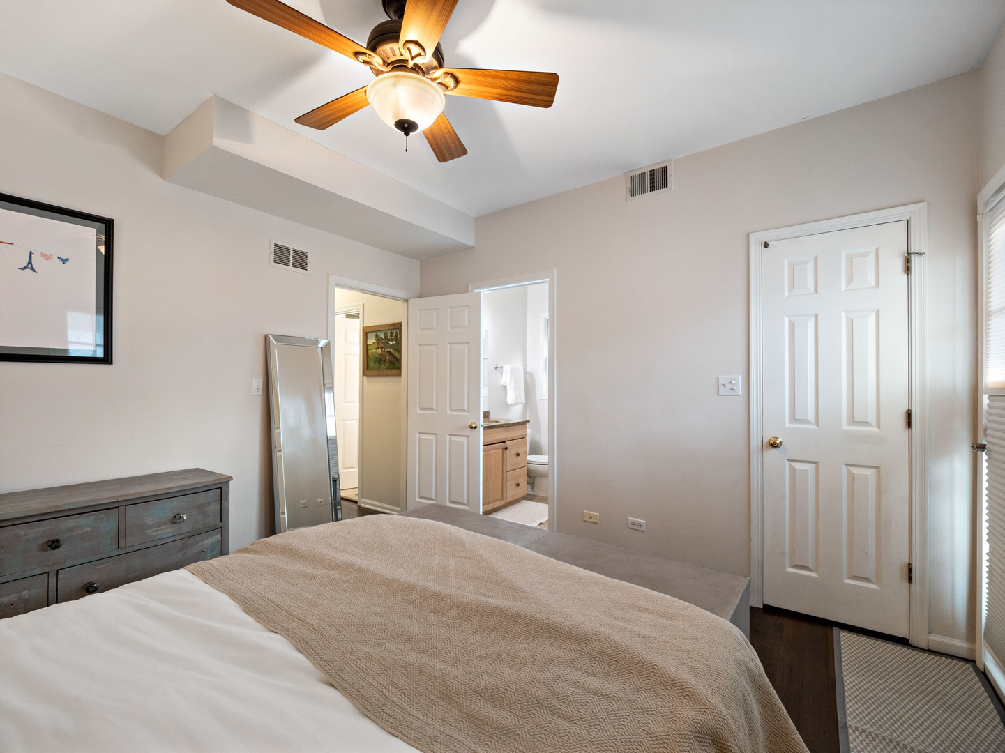 1531 West Walton Street, Unit 1 Chicago, IL 60642 - Photo 11 of 20 a bedroom with a bed and a chandelier