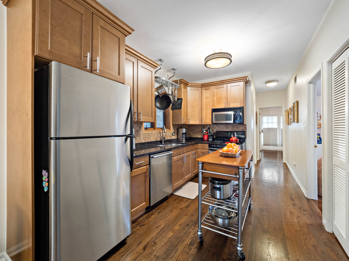 1531 West Walton Street, Unit 1 Chicago, IL 60642 - Photo 6 of 20 a kitchen with wooden floors and wooden cabinets