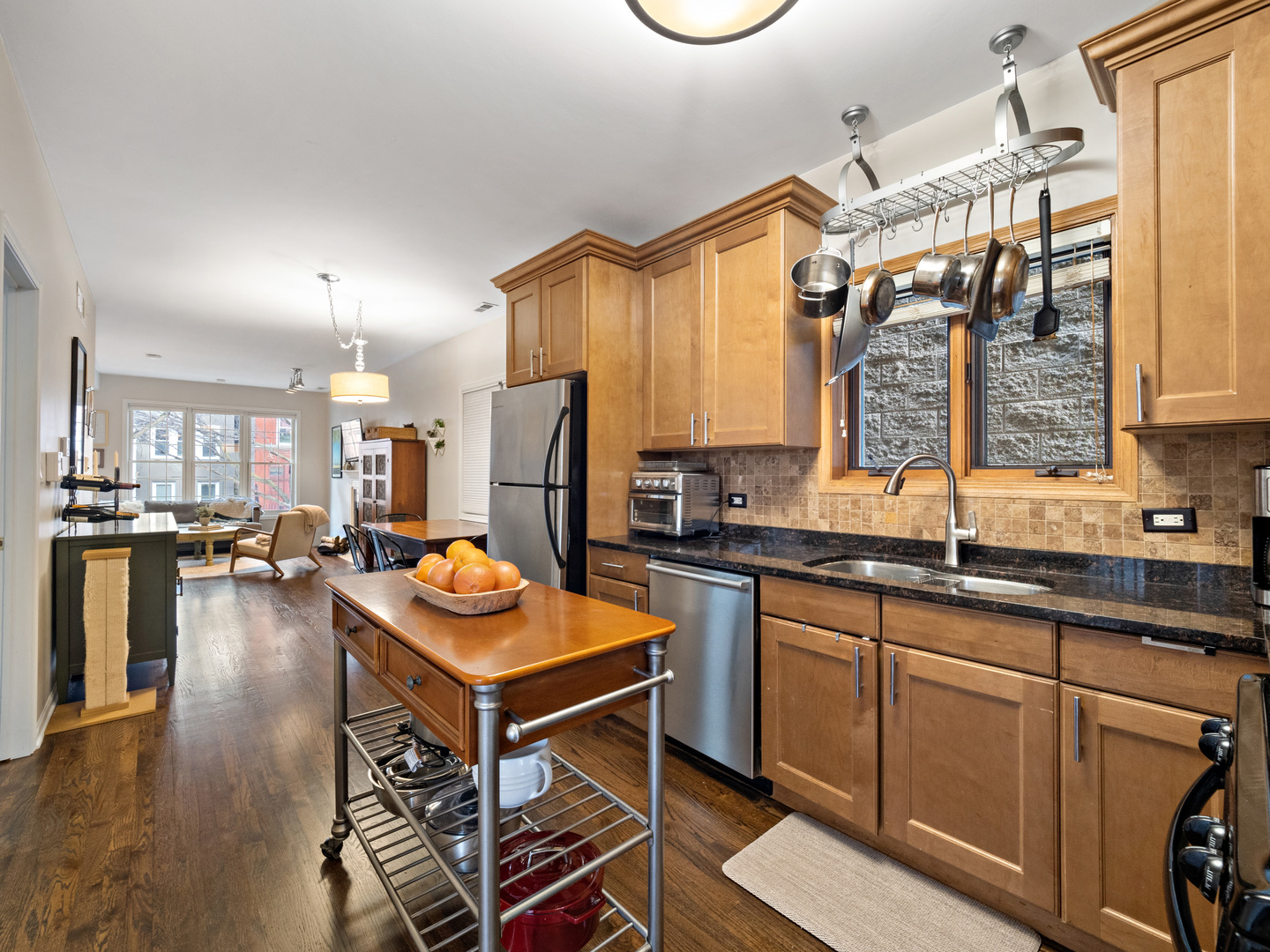 1531 West Walton Street, Unit 1 Chicago, IL 60642 - Photo 7 of 20 a kitchen with stainless steel appliances granite countertop a stove a sink dishwasher and a refrigerator with wooden floor