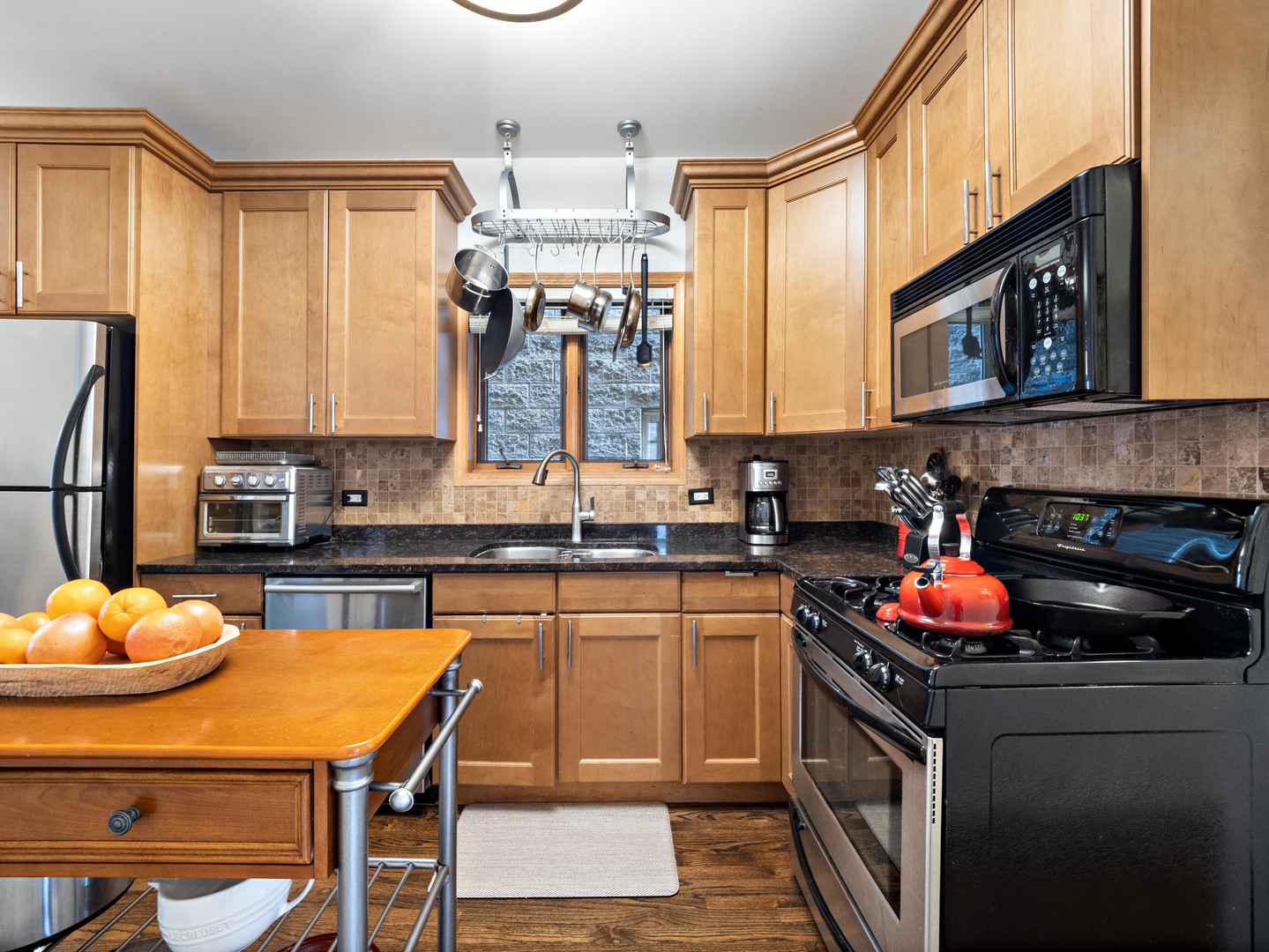 1531 West Walton Street, Unit 1 Chicago, IL 60642 - Photo 8 of 20 a kitchen with stainless steel appliances granite countertop a sink dishwasher and cabinets with wooden floor