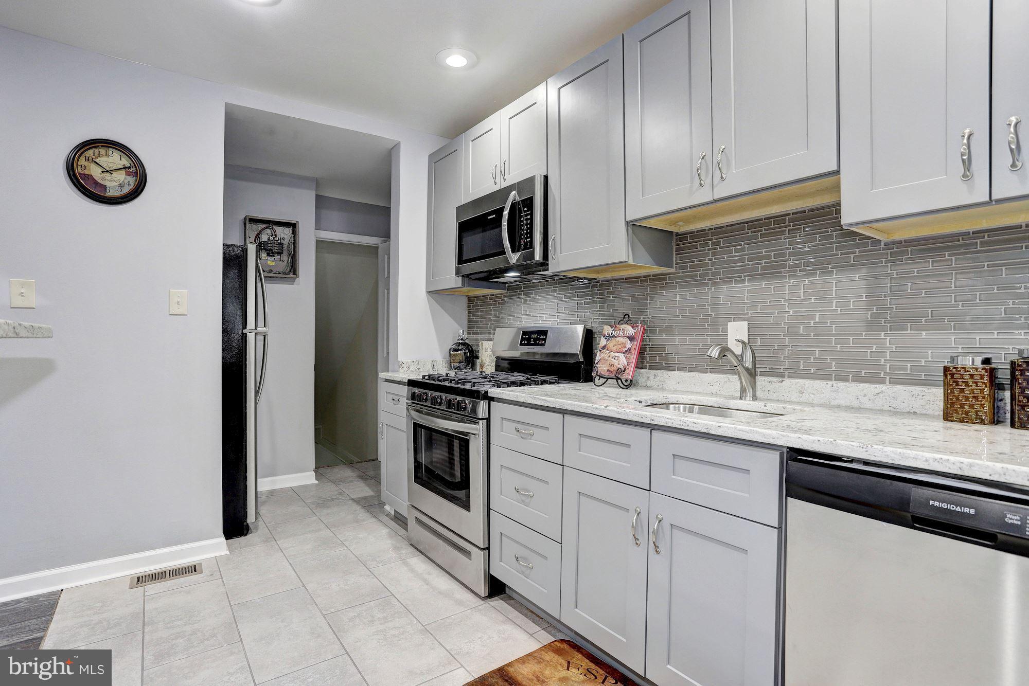 4510 Marble Hall Road Baltimore, MD 21239 - Photo 11 of 24 a kitchen with stainless steel appliances granite countertop a sink stove oven and refrigerator