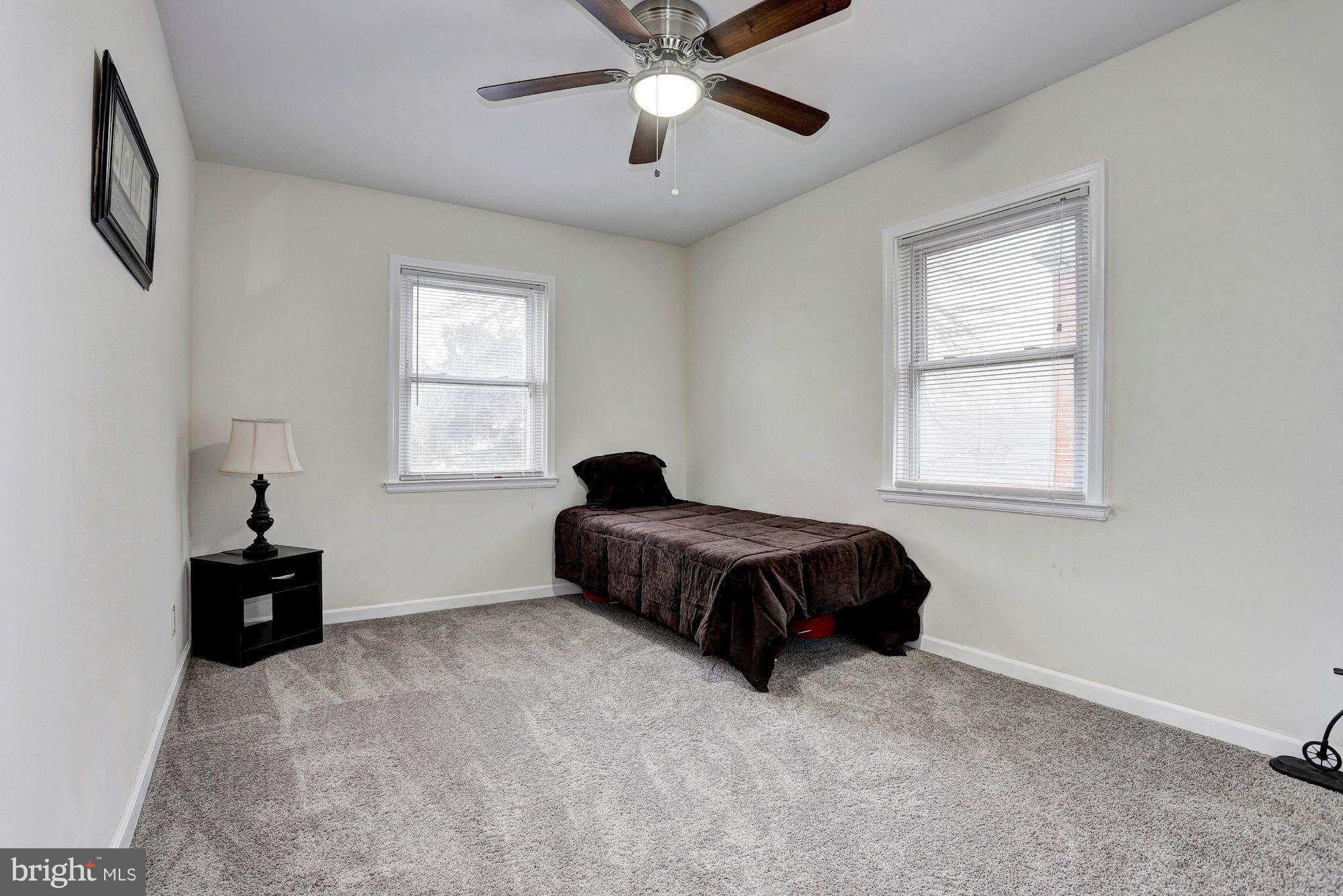 4510 Marble Hall Road Baltimore, MD 21239 - Photo 14 of 24 a bedroom with a bed and window