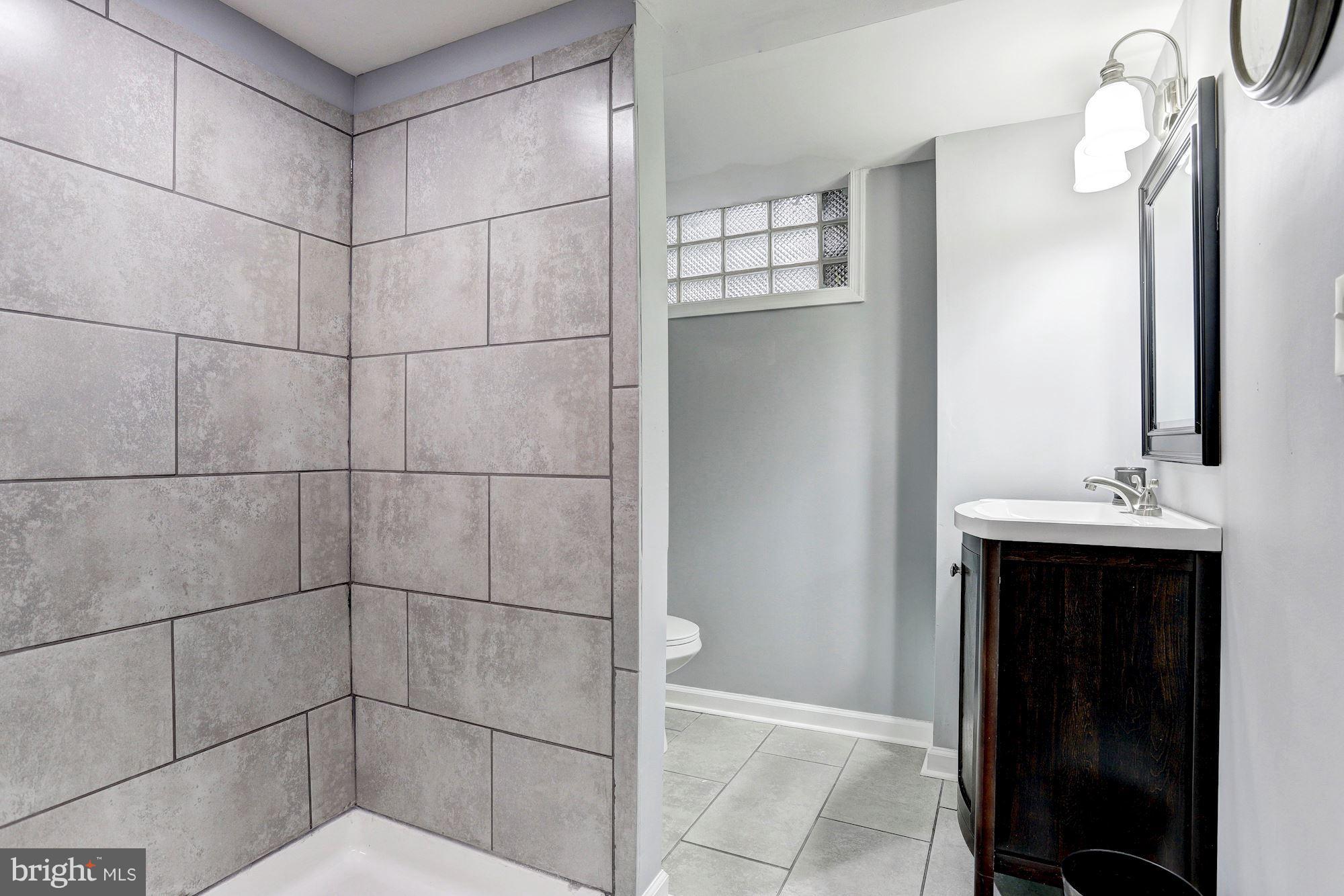 4510 Marble Hall Road Baltimore, MD 21239 - Photo 19 of 24 a bathroom with a sink shower and a mirror