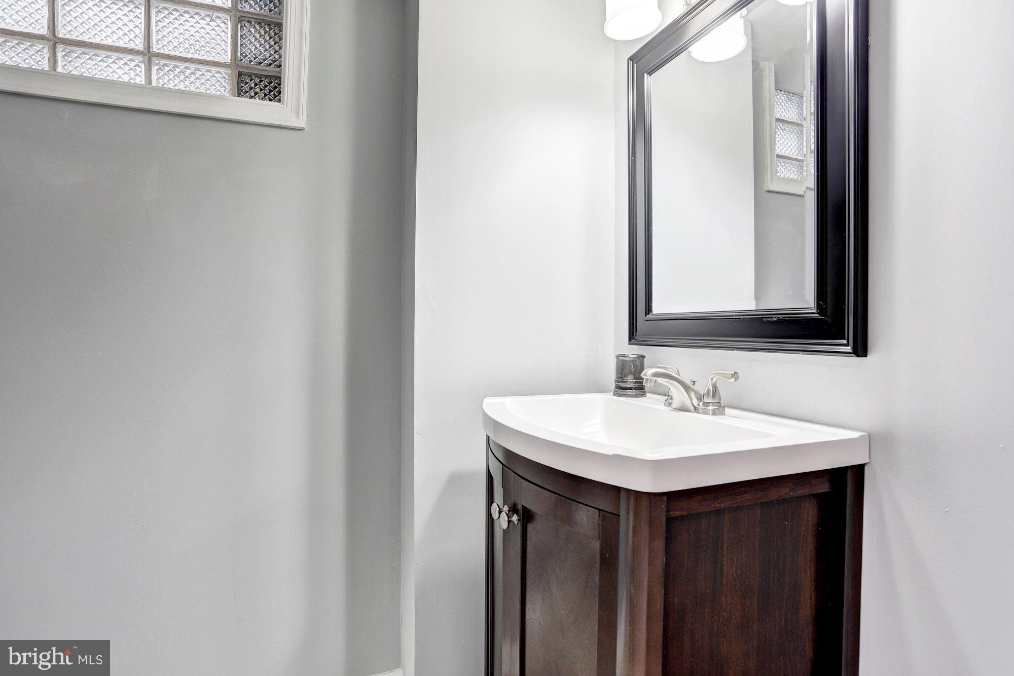 4510 Marble Hall Road Baltimore, MD 21239 - Photo 20 of 24 a bathroom with a sink and a mirror