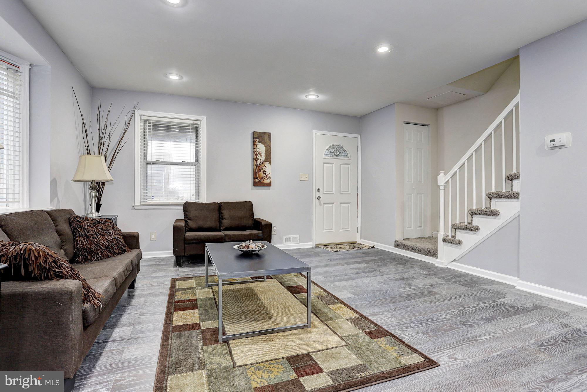 4510 Marble Hall Road Baltimore, MD 21239 - Photo 5 of 24 a living room with furniture and a rug
